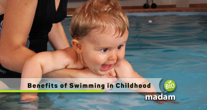 trainer teaching swimming to a baby because there are many benefits of swimming