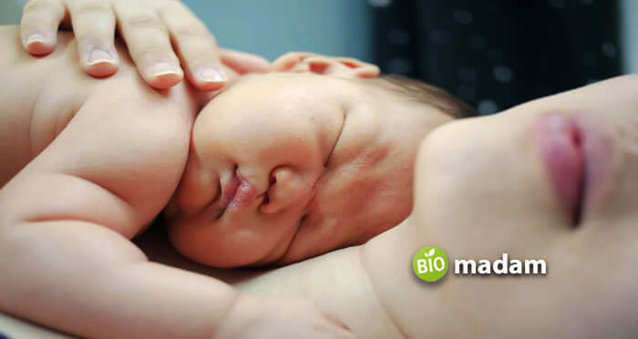 baby sleeping on mother stomach 