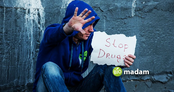 Man holding stop drug on paper