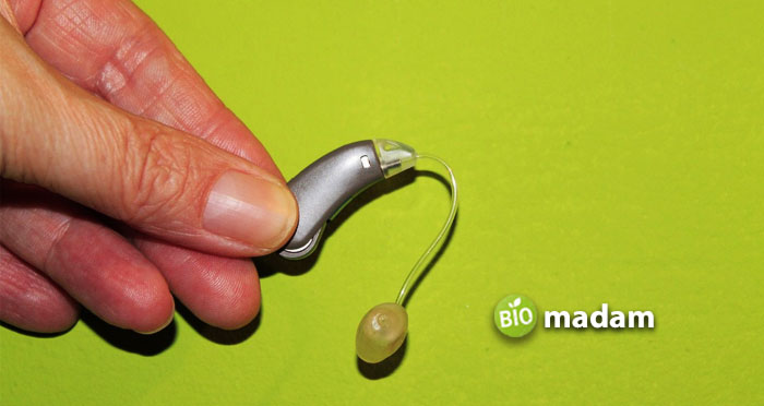 man-hand-holding-hearing-aid