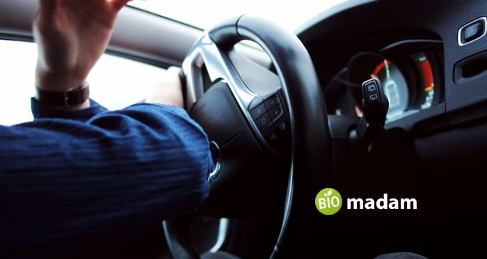 person-holding-car-steering-wheel