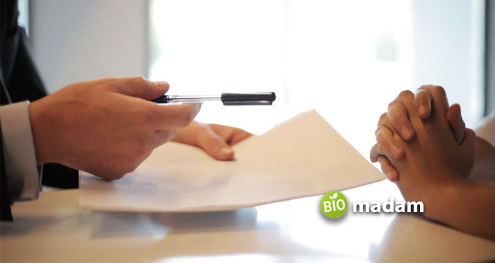 businessman-giving-contract-to-woman-to-sign