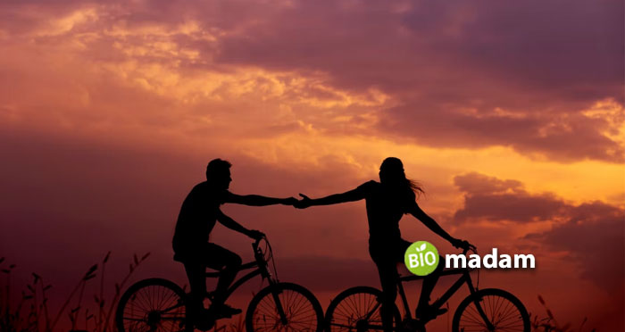 Man-and-Woman-biking-and-hold-hands